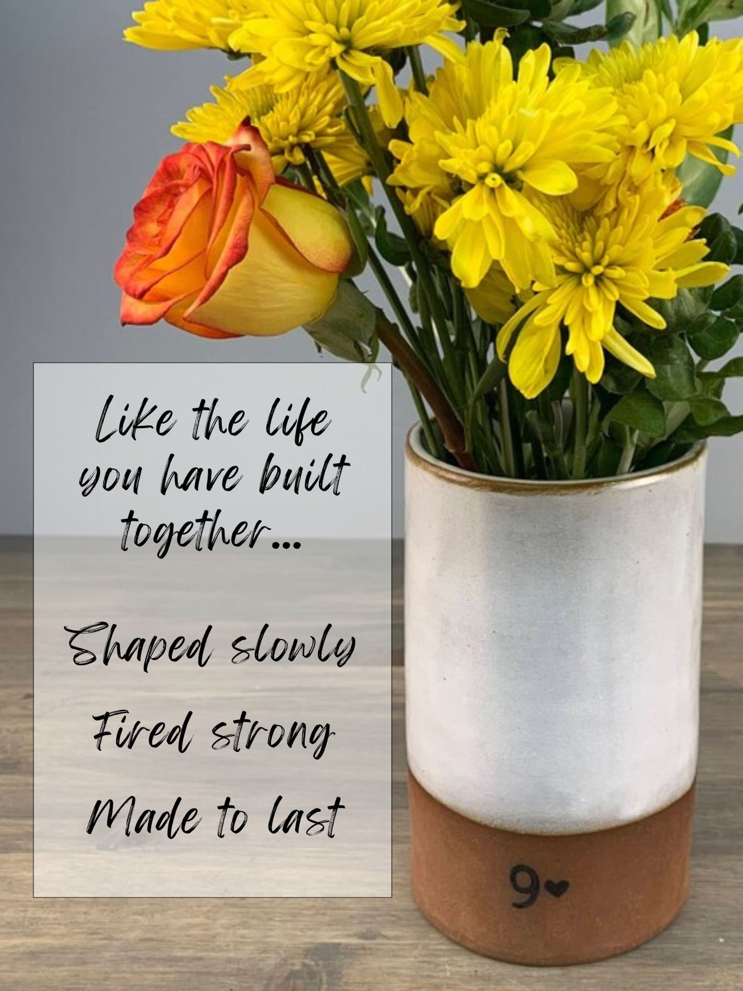 handmade pottery Vase with yellow flowers and a rose on a wooden surface, with a sentimental phrase about pottery