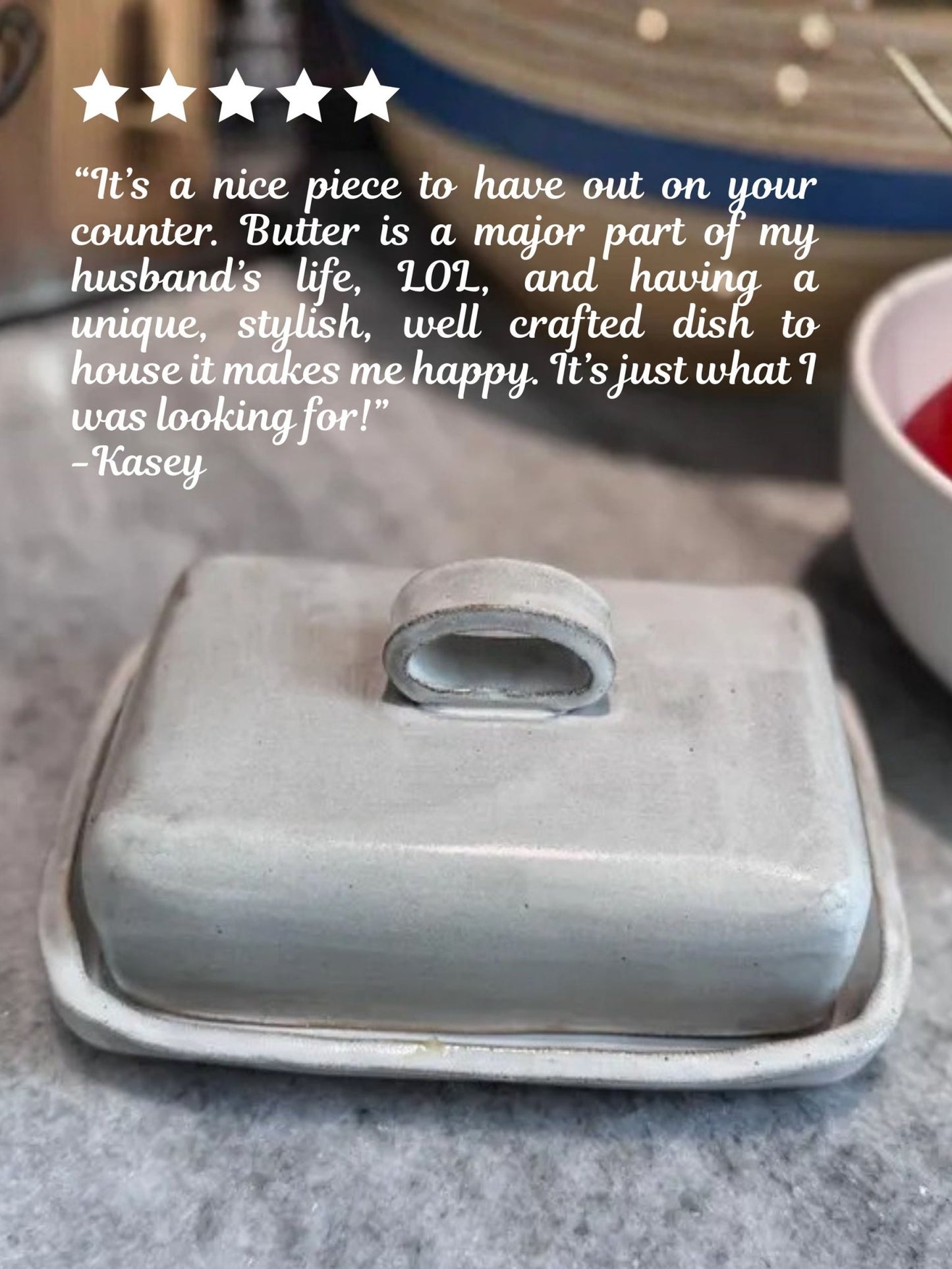 Butter dish with a five-star rating and customer review on a kitchen counter.