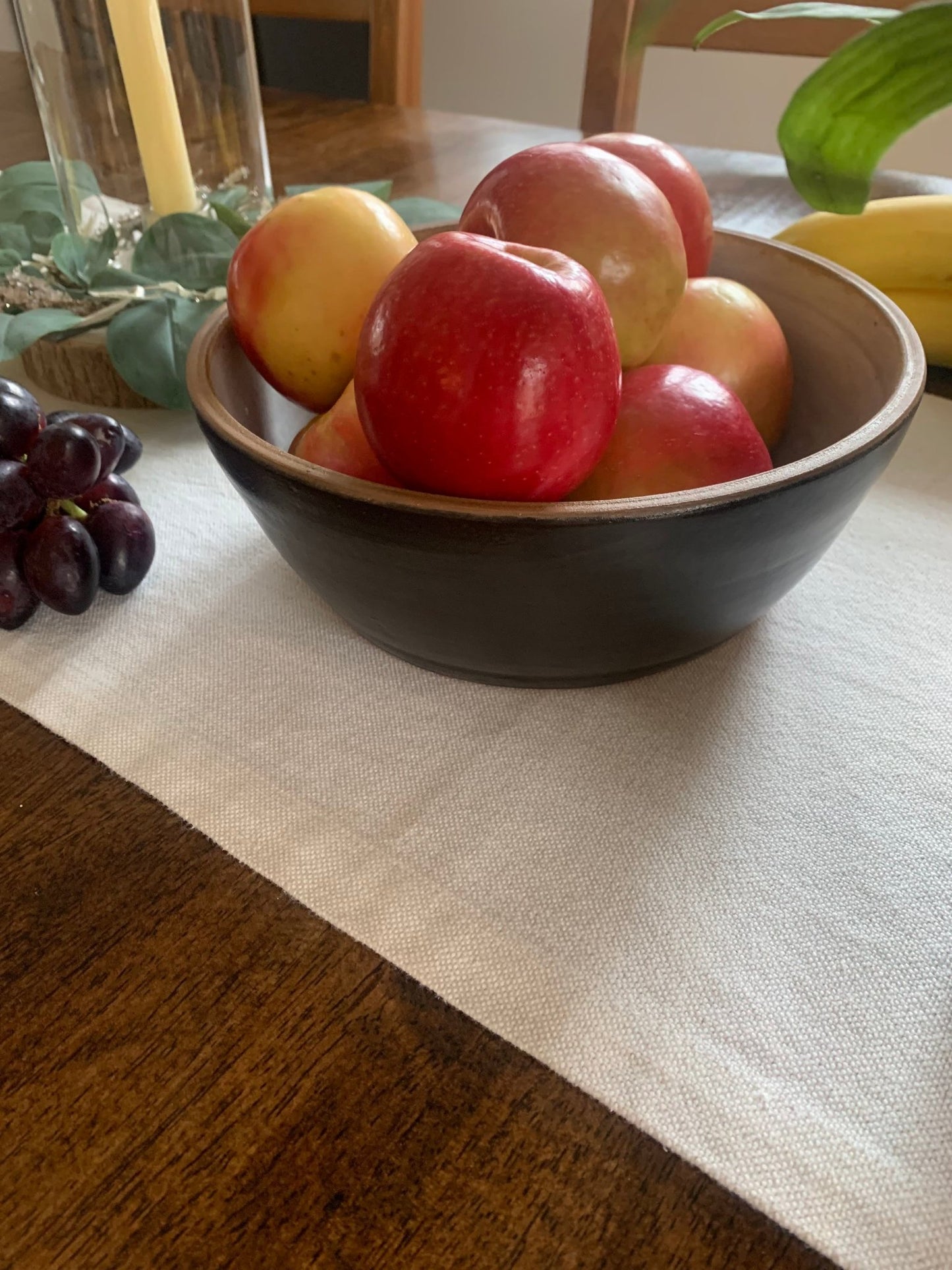 Bowl of apples on a table with a placemat
