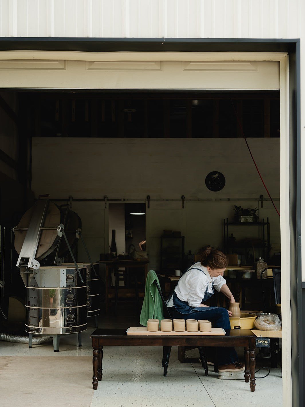 Person working with clay in a pottery studio