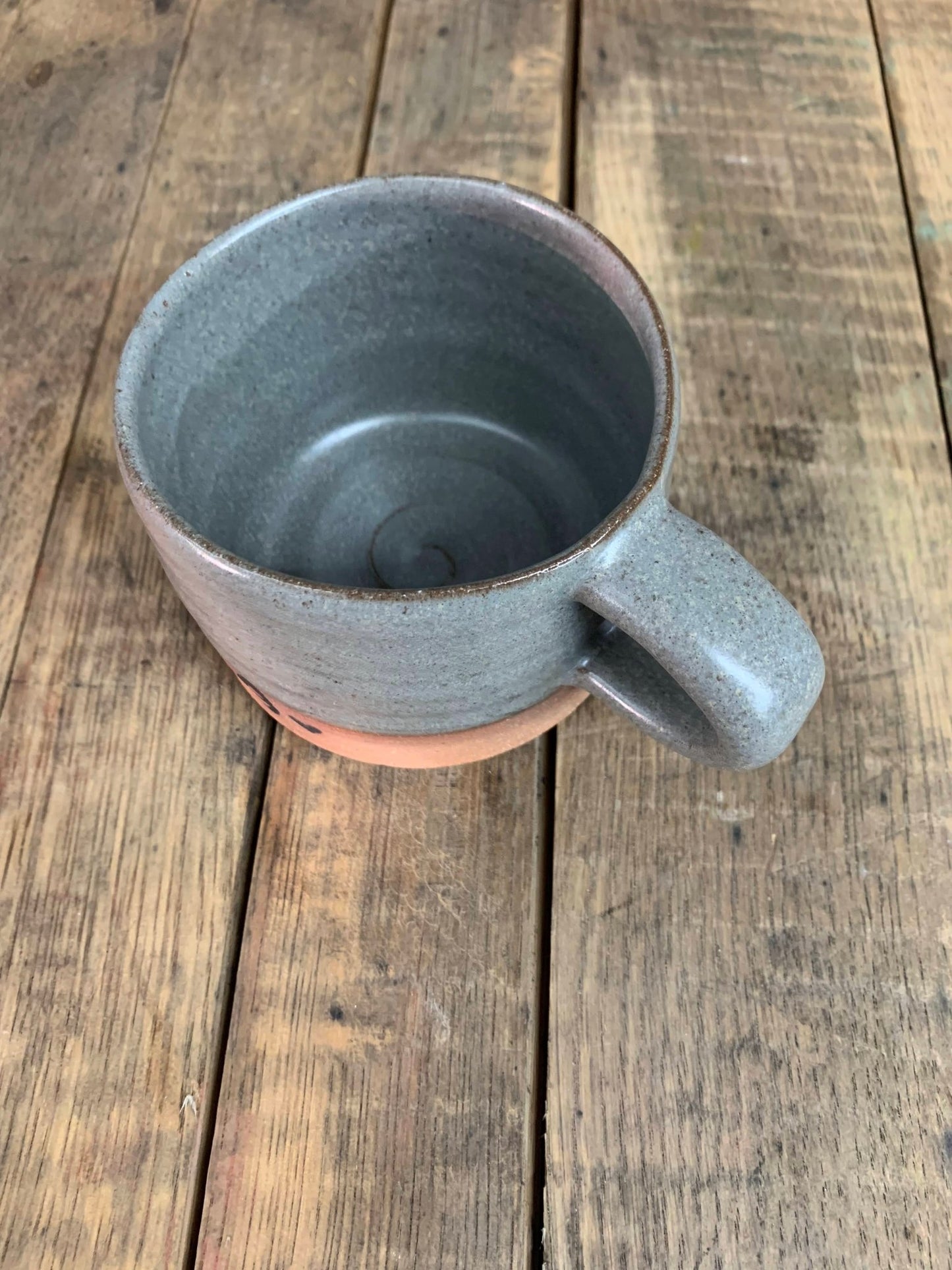 Gray ceramic mug on a wooden surface