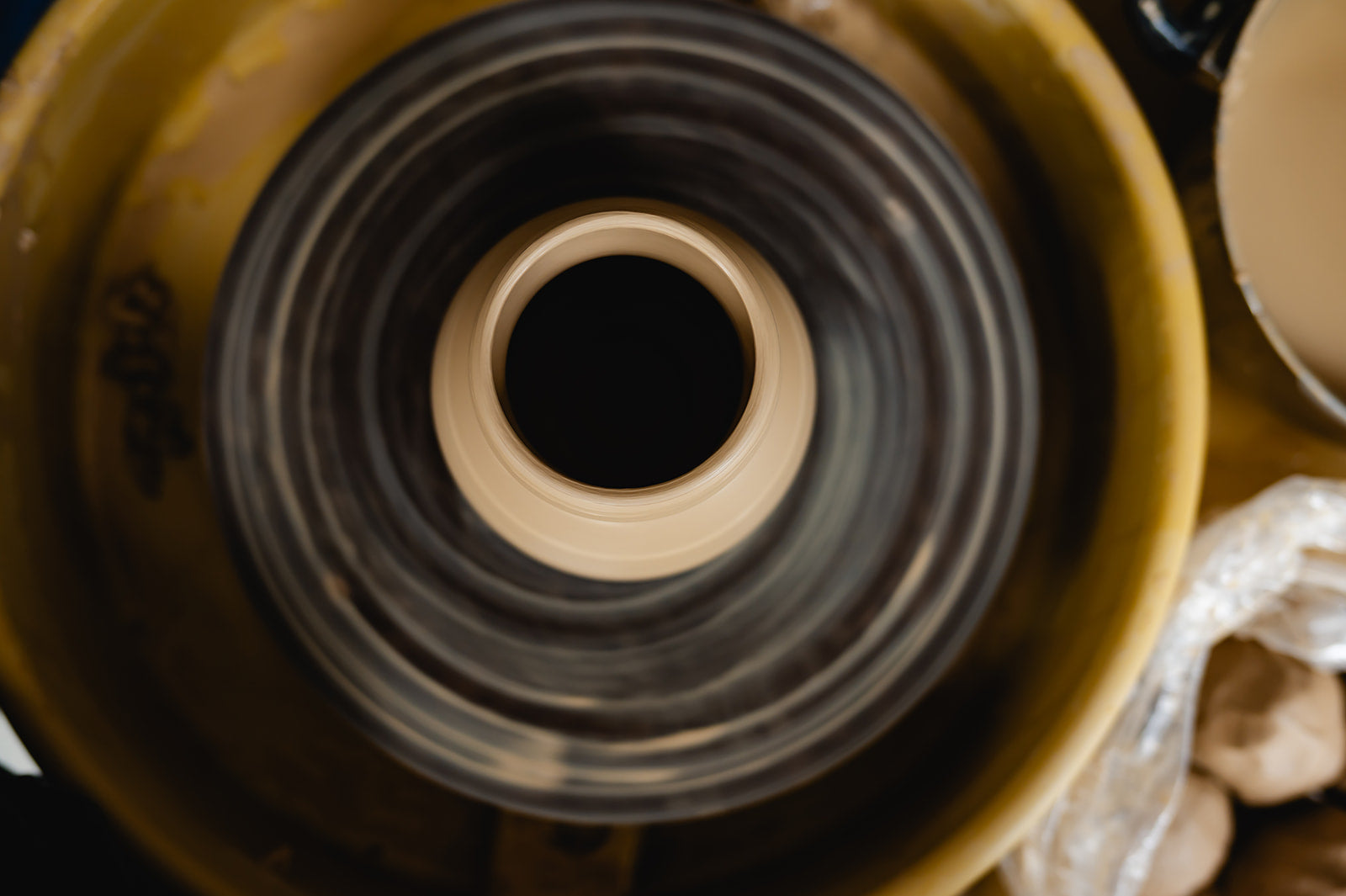 Close-up of a clay vase being made on a potter's wheel