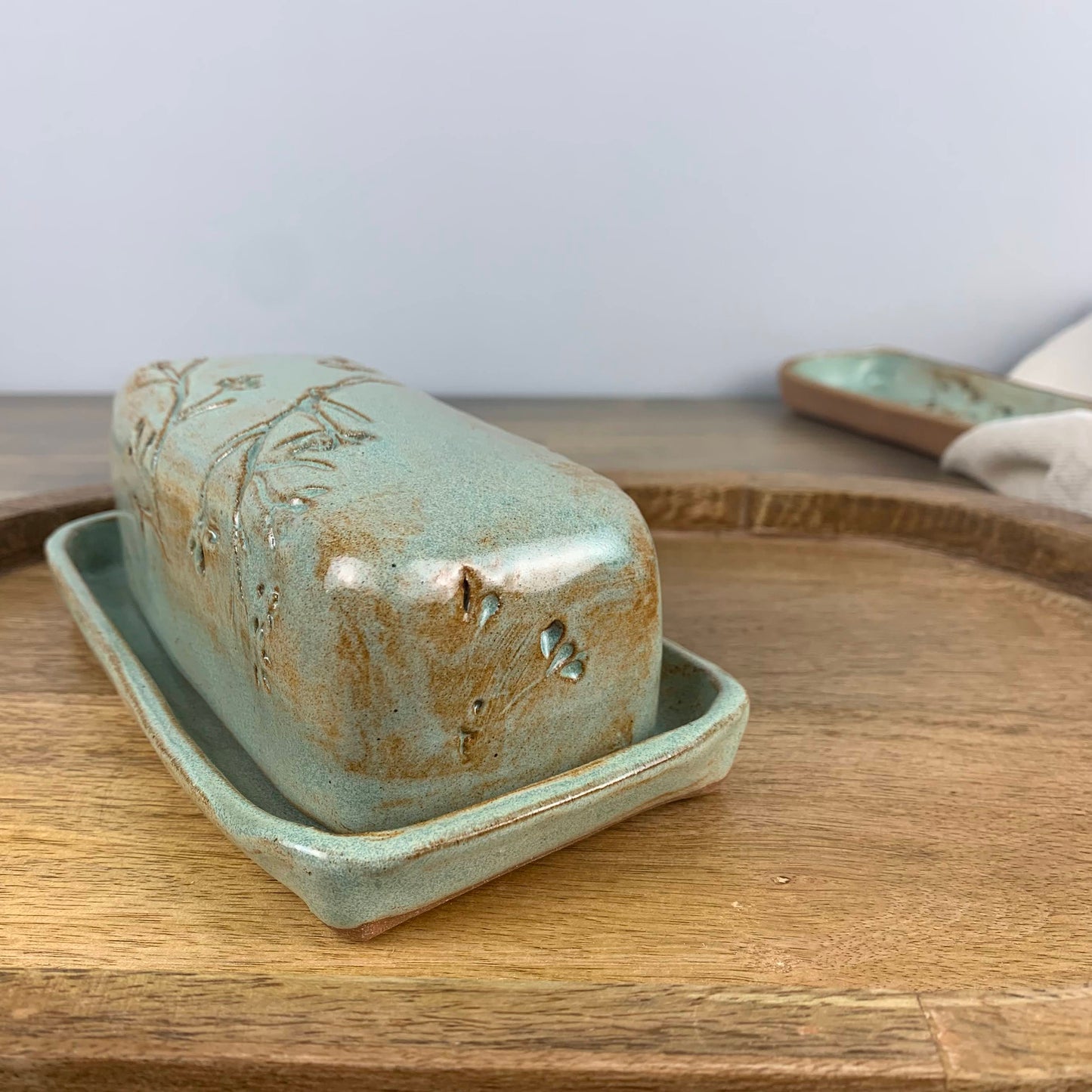 Ceramic butter dish with lid on a wooden surface