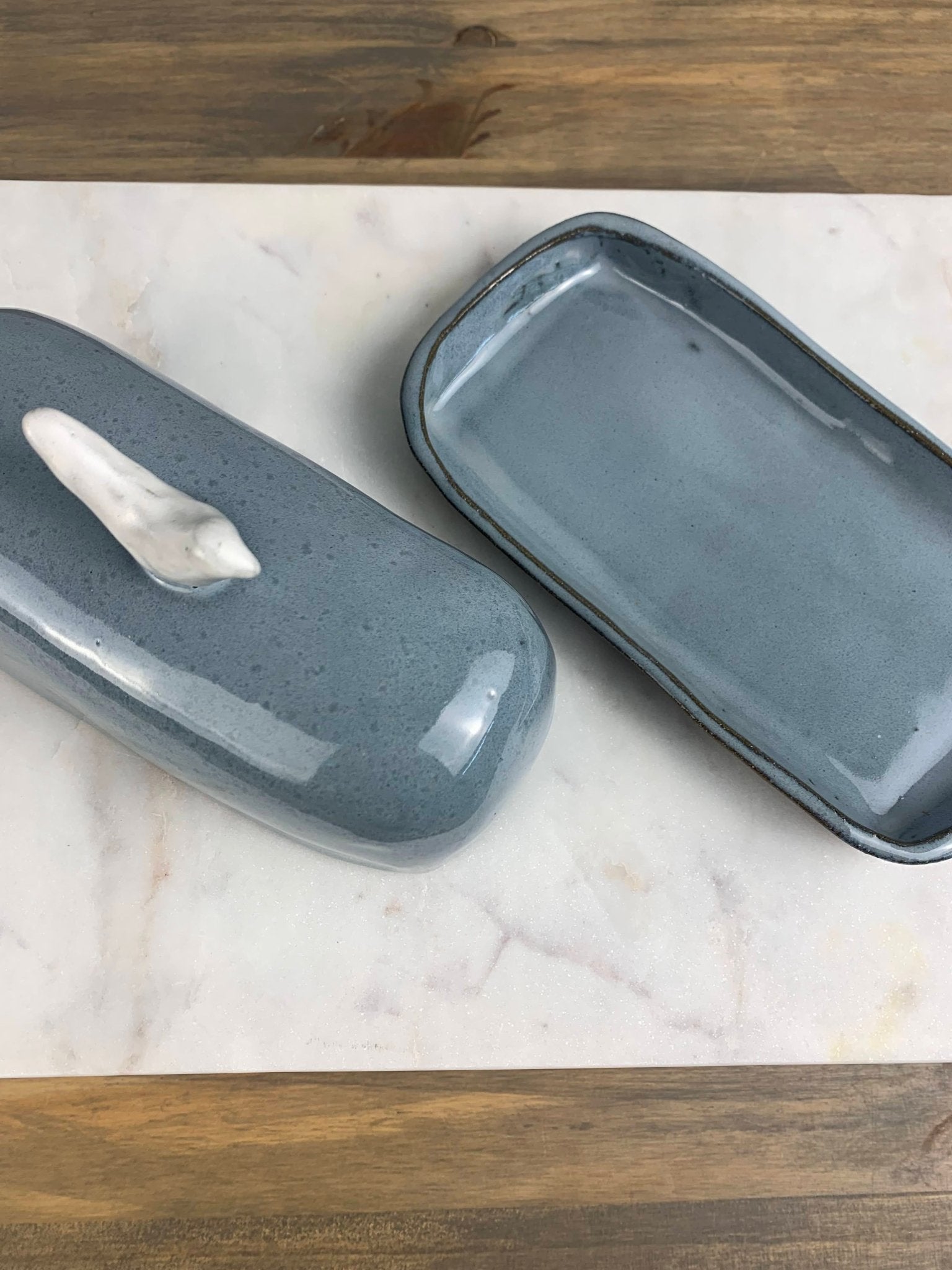 the top and bottom of a butter dish next to each other