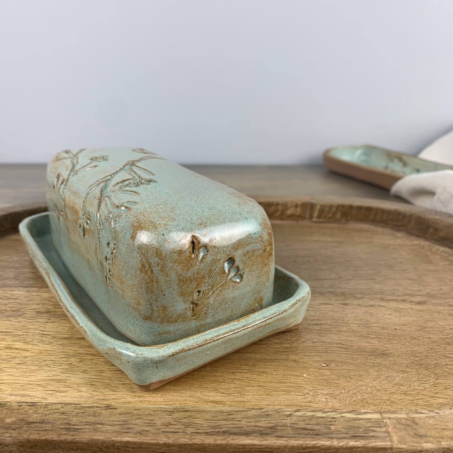 Ceramic butter dish with lid on a wooden surface