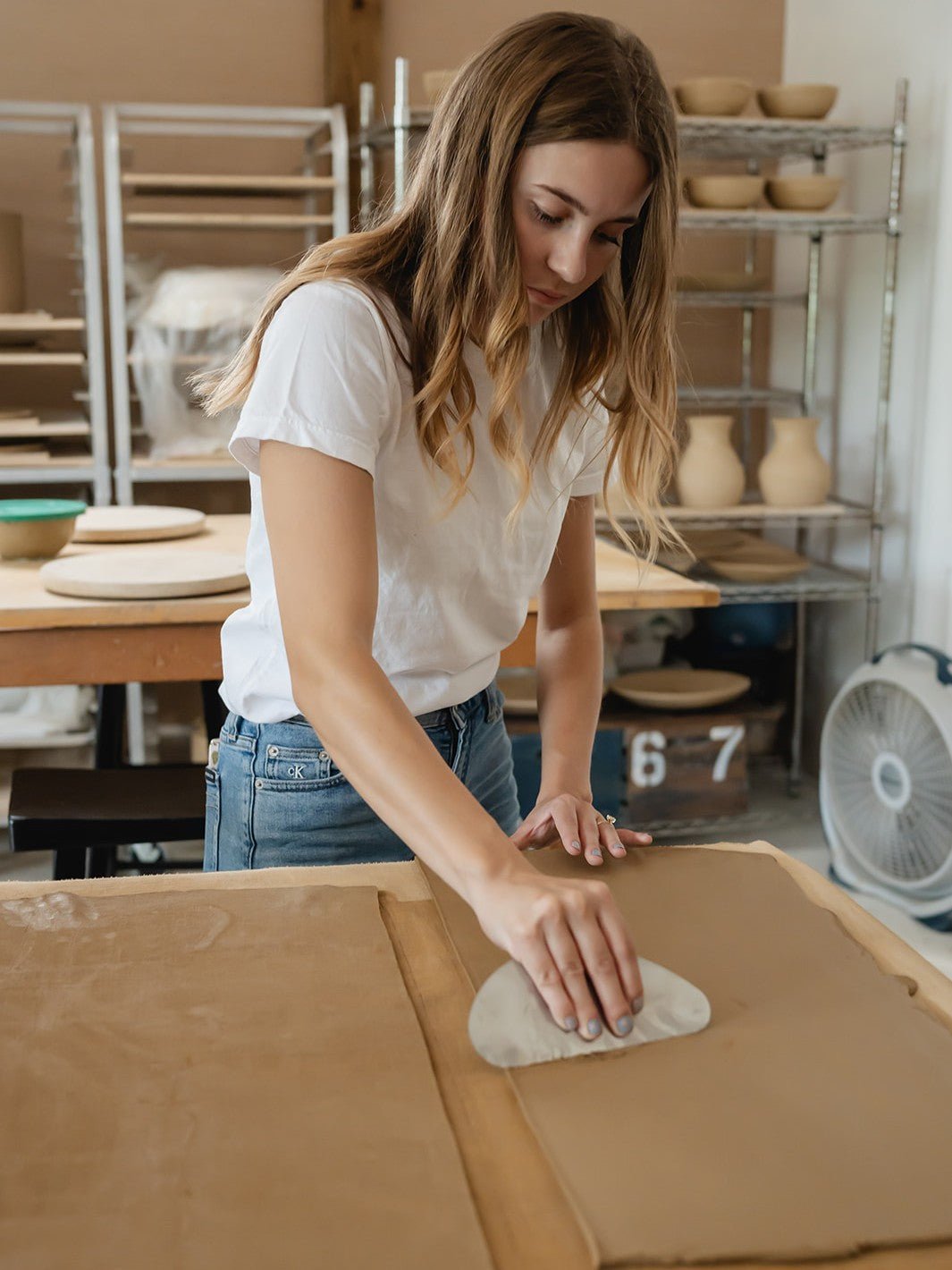 Woman working with clay in a pottery studio