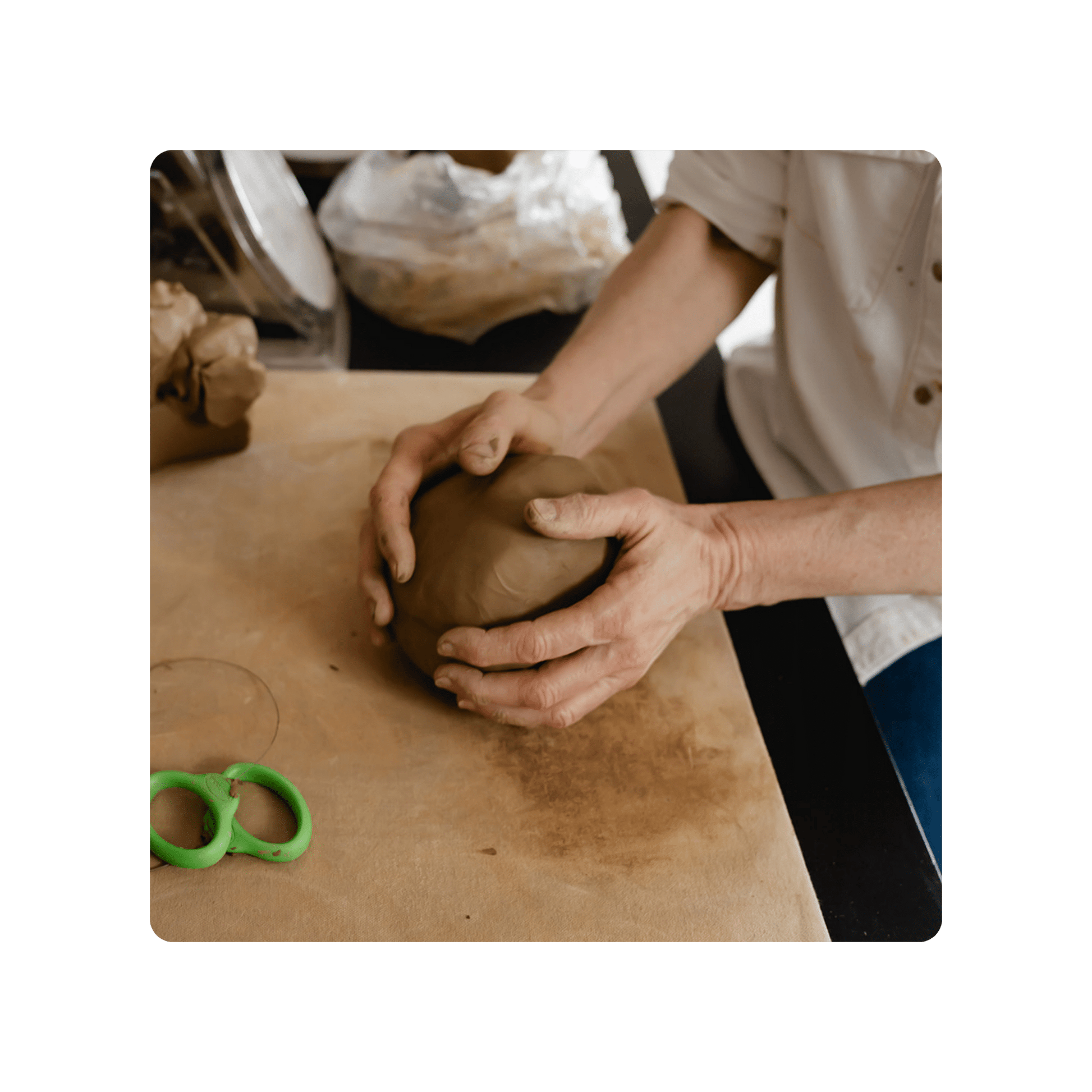 Person shaping a clay lump