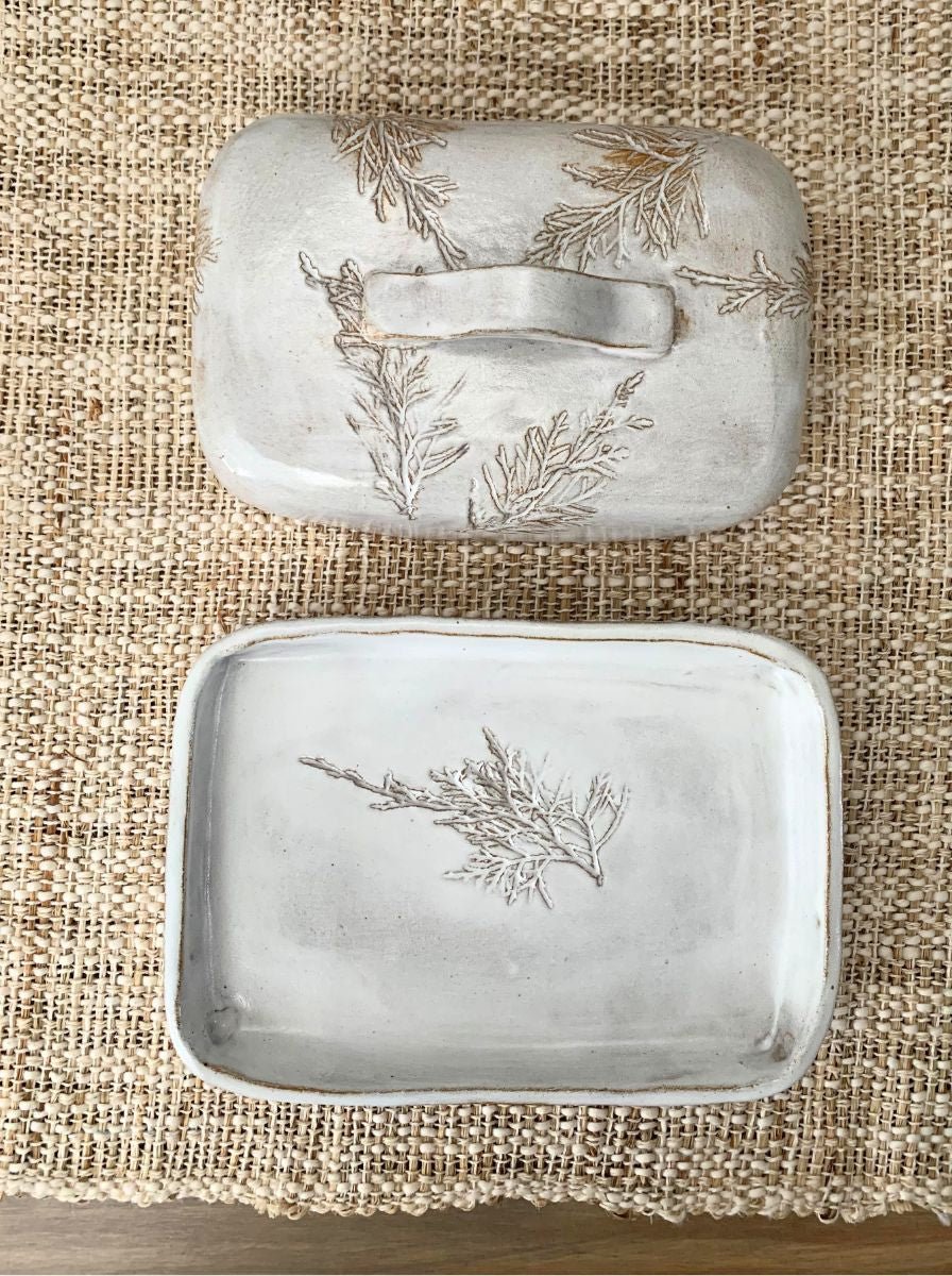 the top and bottom of a large handcrafted butter dish 