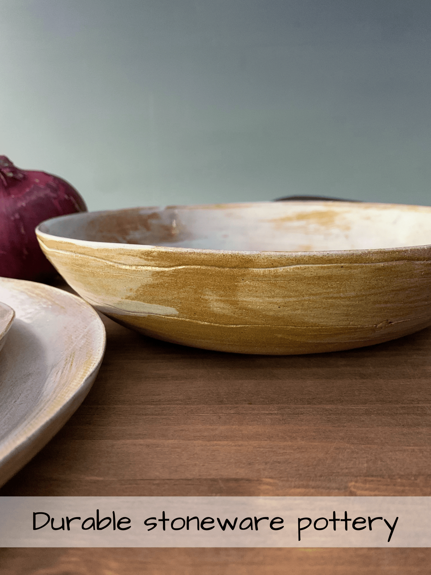 Stoneware bowls on a wooden surface with a text overlay about durability.