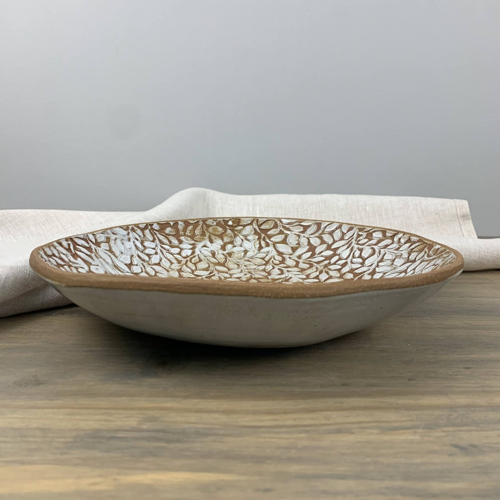 Ceramic bowl with textured design on a wooden surface