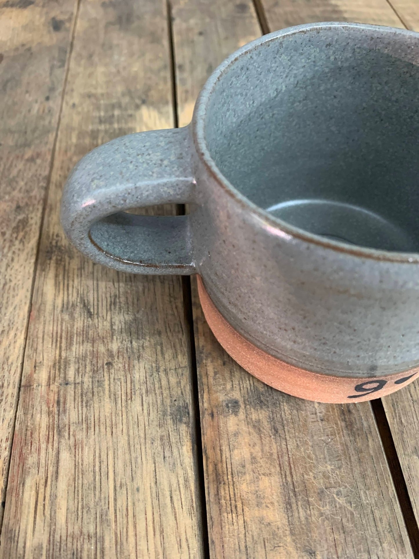Gray ceramic mug on a wooden surface