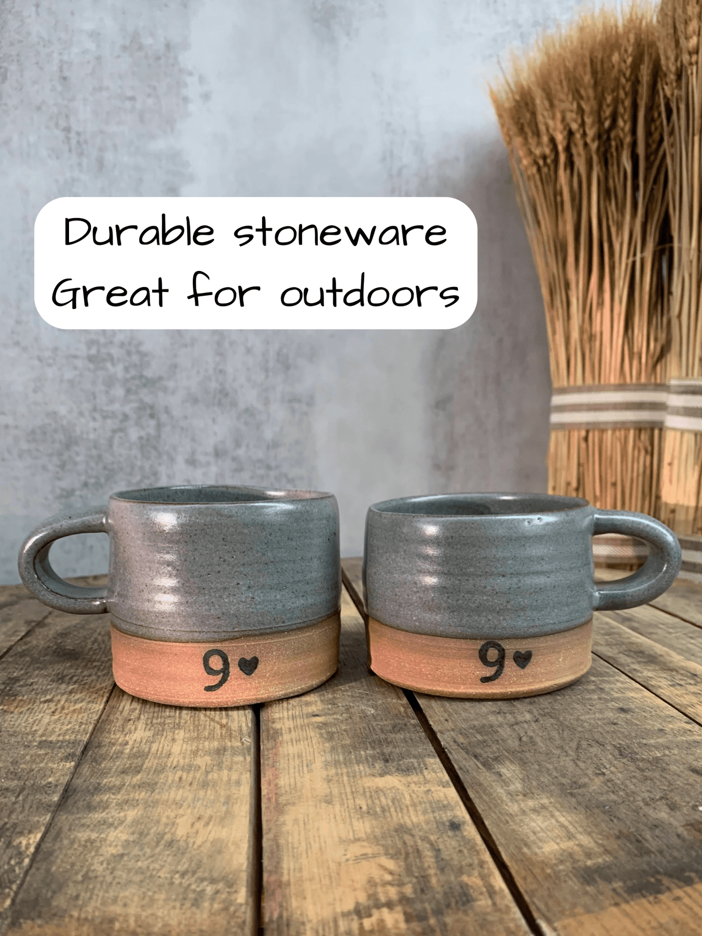 Two gray mugs with wooden bases on a wooden surface, text indicating durability and suitability for outdoors.