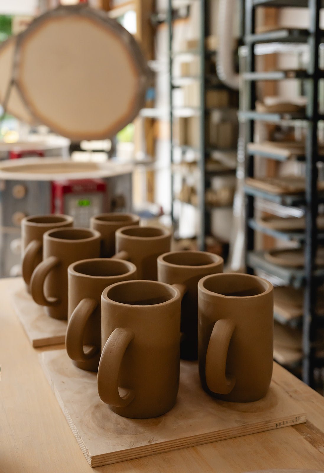 clay mugs on a table in a pottery studio