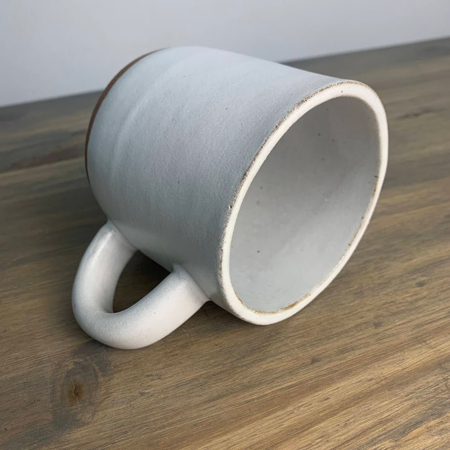 White ceramic mug on a wooden surface